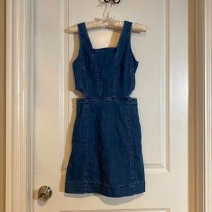 Jean dress, cut out on side and has pockets